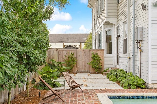 view of patio / terrace with a fenced in pool