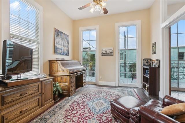 living area with light hardwood / wood-style floors and ceiling fan