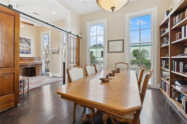 dining space with dark hardwood / wood-style floors and a barn door