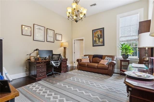 home office featuring a notable chandelier and wood-type flooring