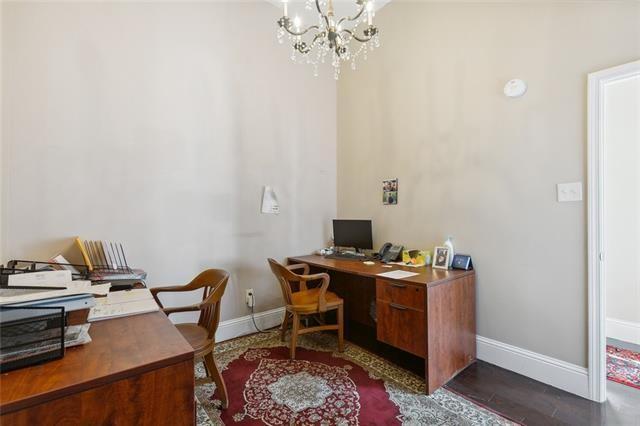 office featuring dark hardwood / wood-style flooring and a notable chandelier