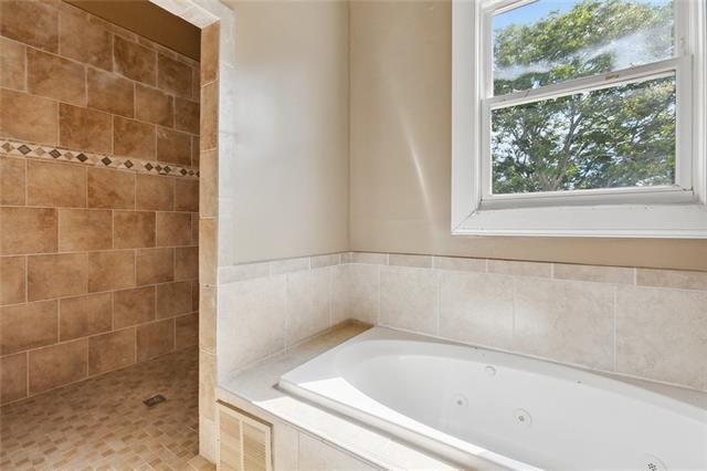 bathroom with separate shower and tub