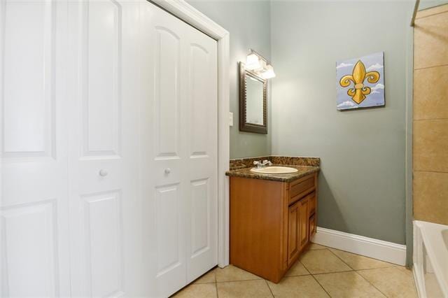 bathroom with tile patterned flooring, shower with separate bathtub, and vanity