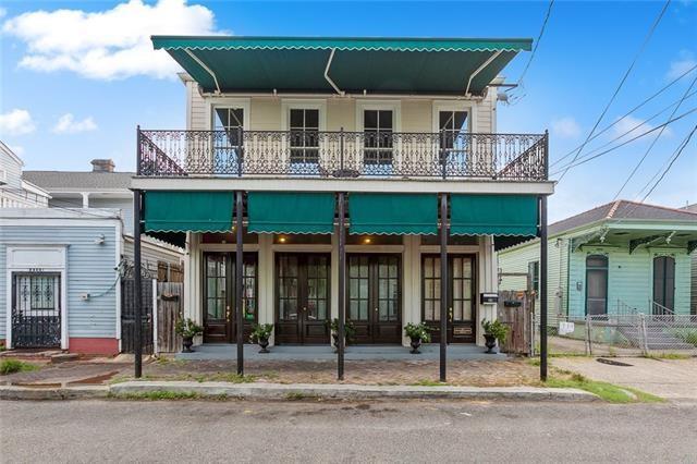 view of front of house with french doors and a balcony