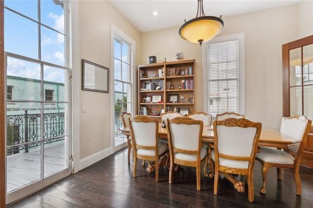1027 Ninth St, New Orleans, LA 70115 - dining space featuring dark wood-style flooring and baseboards