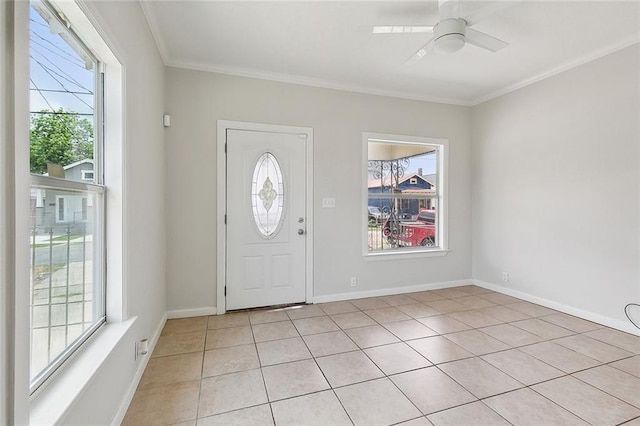 tiled entrance foyer with crown molding and ceiling fan