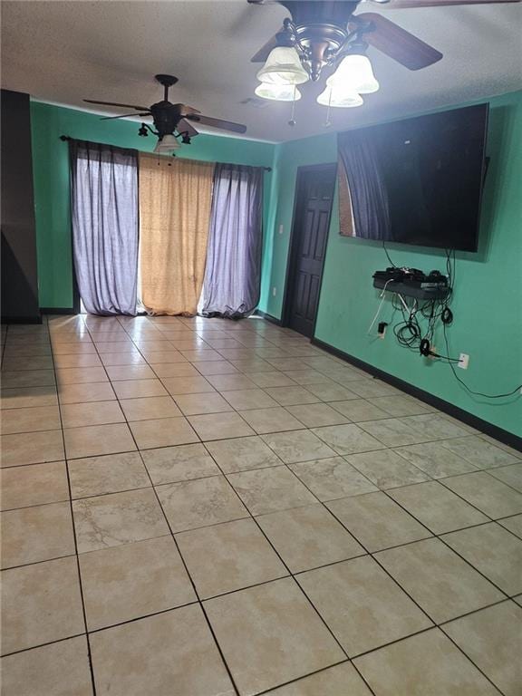 tiled spare room featuring a notable chandelier and a textured ceiling