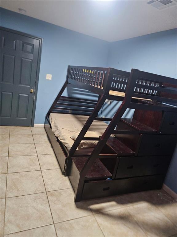 bedroom with light tile patterned flooring