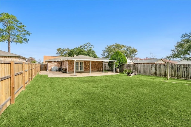 back of property featuring a patio area and a yard