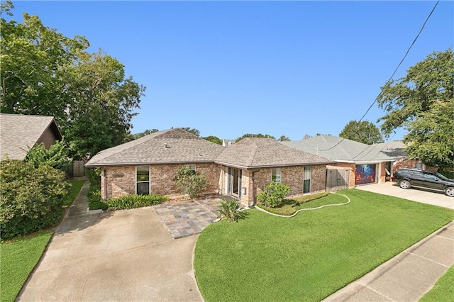 single story home with a garage and a front lawn