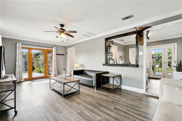 living room featuring ceiling fan, hardwood / wood-style floors, french doors, and ornamental molding