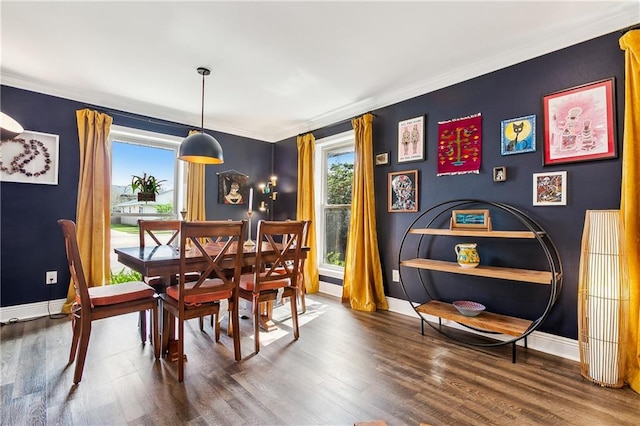 dining space with dark wood-type flooring and ornamental molding