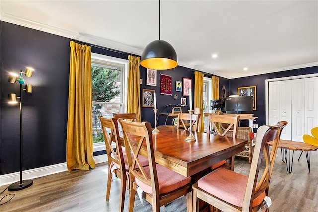 dining area with hardwood / wood-style floors and ornamental molding