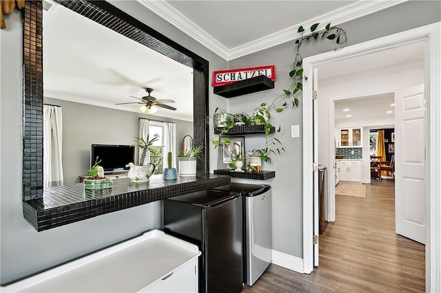 kitchen featuring backsplash, refrigerator, crown molding, hardwood / wood-style flooring, and ceiling fan