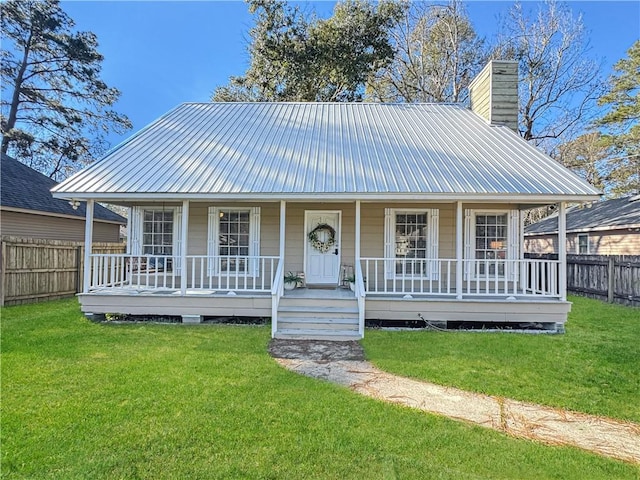 farmhouse with covered porch and a front yard