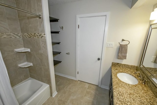 bathroom with tile patterned floors, vanity, and tiled shower / bath combo