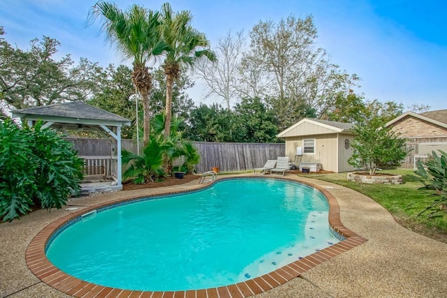 view of pool with a gazebo and an outbuilding