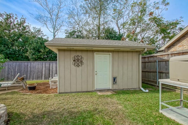 view of outbuilding with a lawn