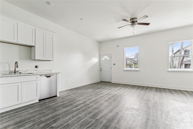 kitchen featuring hardwood / wood-style floors, sink, stainless steel dishwasher, ceiling fan, and white cabinetry