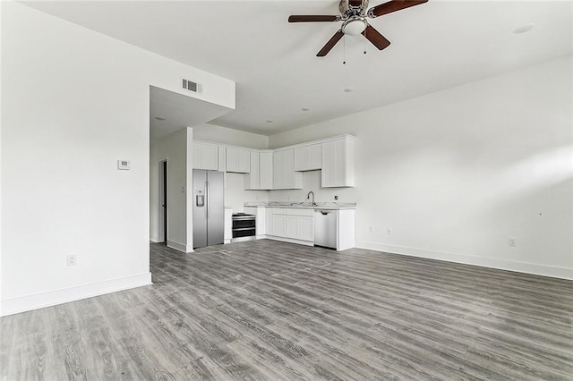 unfurnished living room with ceiling fan, light hardwood / wood-style flooring, and sink