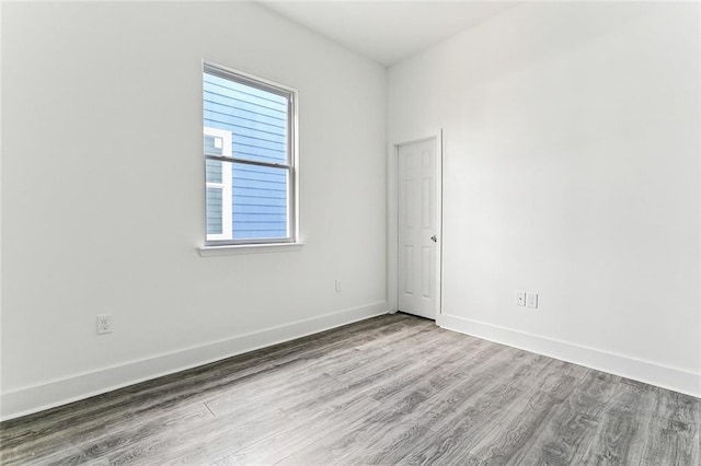 spare room with wood-type flooring