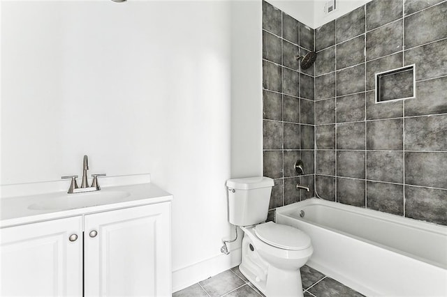 full bathroom featuring tile patterned floors, vanity, tiled shower / bath combo, and toilet