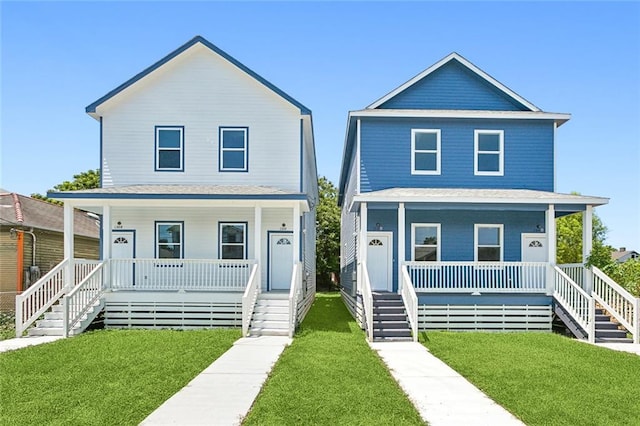 farmhouse inspired home featuring a front lawn and a porch