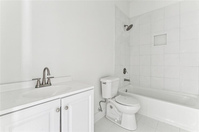 full bathroom with tile patterned floors, vanity, toilet, and tiled shower / bath combo