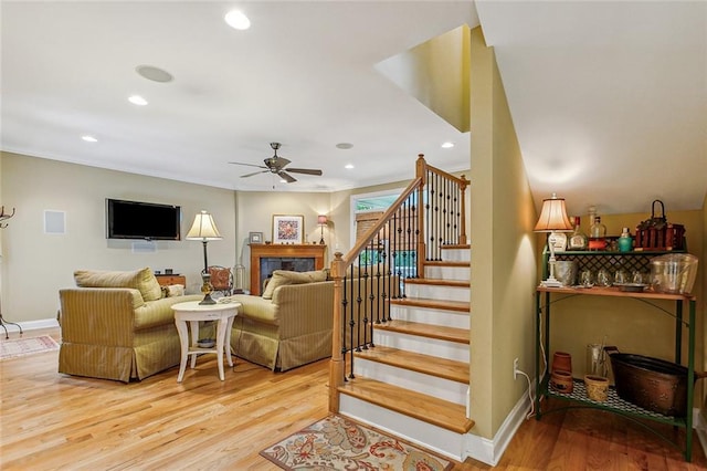 interior space featuring ornamental molding, stairway, wood finished floors, and baseboards