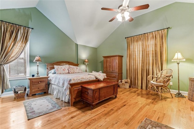 bedroom featuring baseboards, a ceiling fan, vaulted ceiling, and wood finished floors