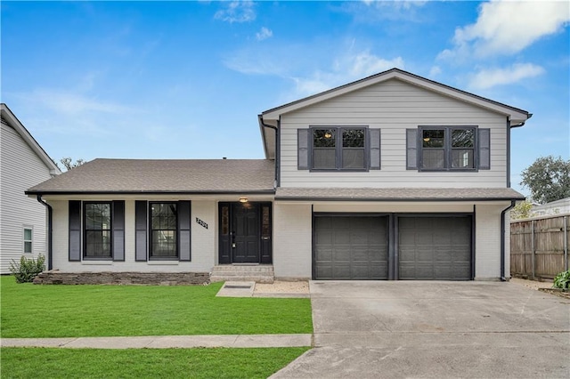 split level home with a garage and a front yard