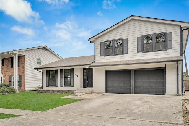 view of front of home with a garage and a front lawn