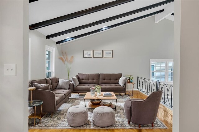 unfurnished room featuring beamed ceiling, high vaulted ceiling, and light hardwood / wood-style floors