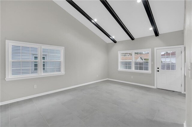 unfurnished living room with high vaulted ceiling, beam ceiling, and sink