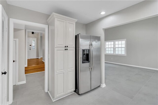 spare room featuring light hardwood / wood-style flooring, ceiling fan, and french doors