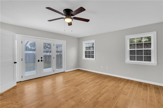 unfurnished bedroom featuring ceiling fan, ensuite bathroom, and light wood-type flooring