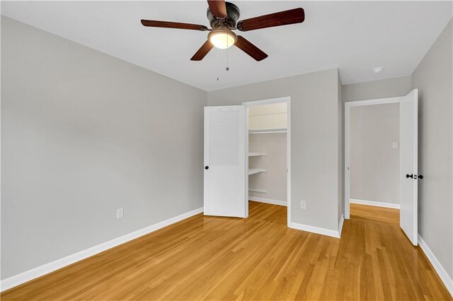 unfurnished room with plenty of natural light, ceiling fan, and light wood-type flooring