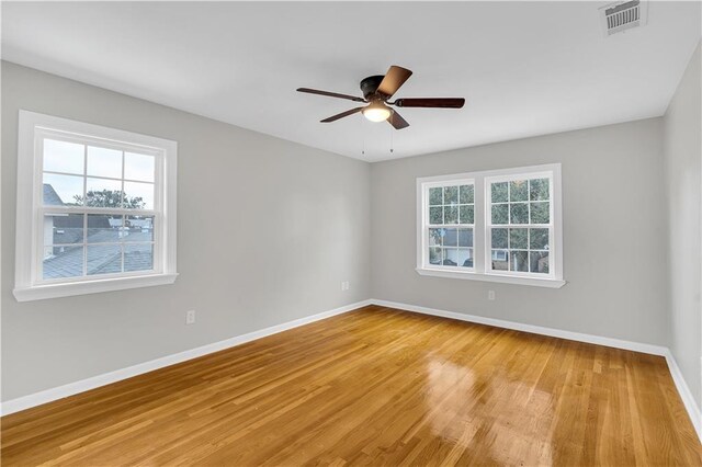 spare room with ceiling fan and light hardwood / wood-style floors