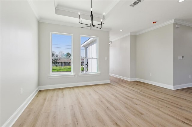 unfurnished dining area featuring light hardwood / wood-style floors, ornamental molding, and a notable chandelier