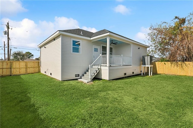 rear view of house with a lawn and ceiling fan