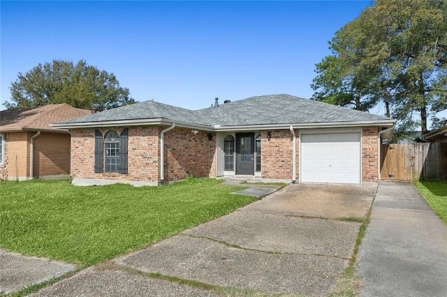 ranch-style home featuring a front lawn and a garage