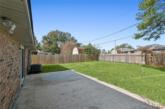 view of yard with cooling unit and a patio area