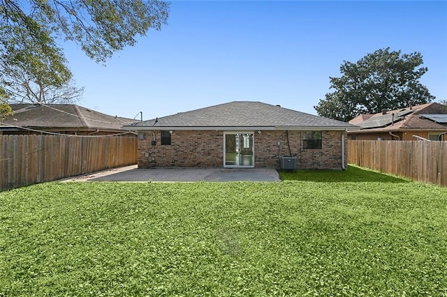 back of house with central air condition unit, a lawn, and a patio