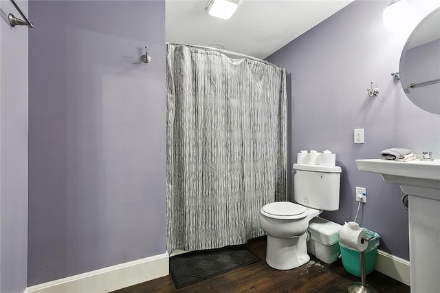 bathroom with a shower with shower curtain, wood-type flooring, and toilet