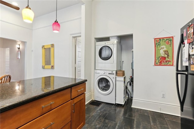 laundry room with stacked washing maching and dryer