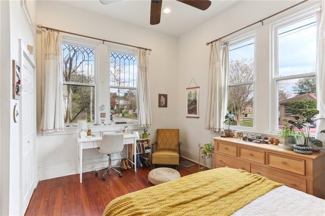 bedroom with dark hardwood / wood-style floors and ceiling fan