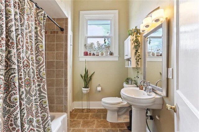 bathroom with toilet and shower / tub combo