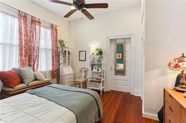 bedroom with ceiling fan and dark hardwood / wood-style flooring