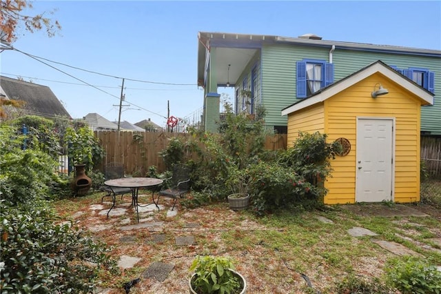 rear view of house with a storage shed