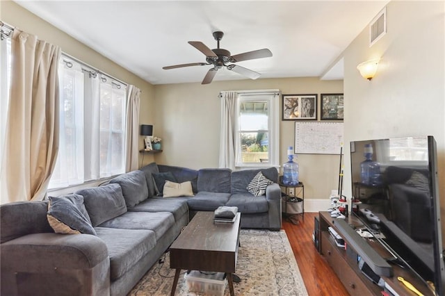 living room featuring dark hardwood / wood-style floors and ceiling fan